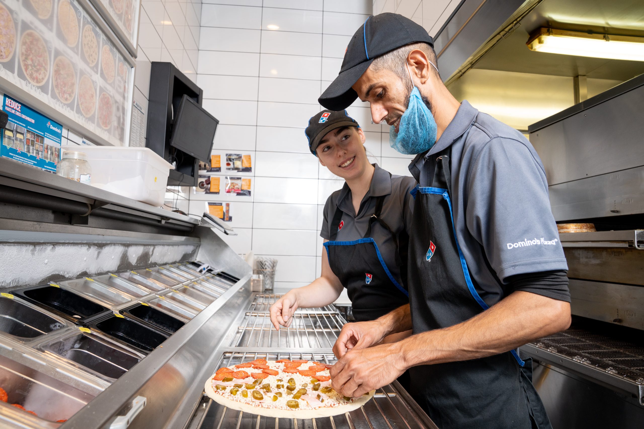 Domino's colleagues making a pizza