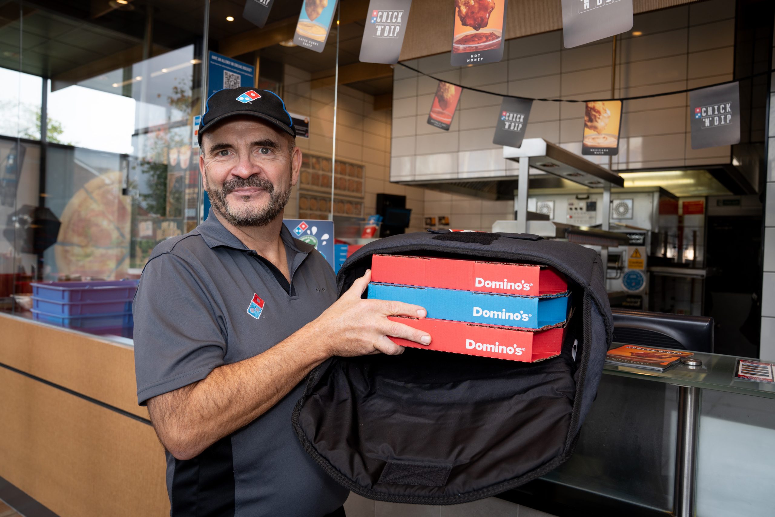 Domino's colleague with pizza boxes